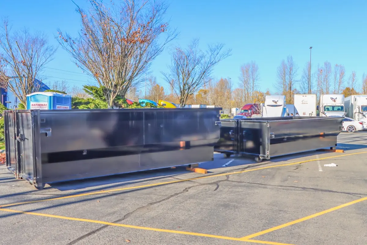 Professional dumpster rental service with roll-off container on residential driveway in Stonecrest